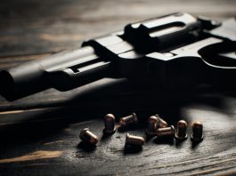 Revolver pistol with Flobert ammo 4mm on dark wooden background