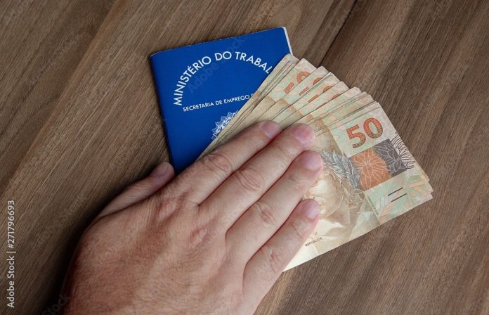 Brazilian document work and social security ( Carteira de Trabalho e Previdencia Social) with brazilian money