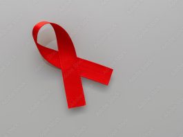 red ribbon of the AIDS prevention campaign, kidney cancer, head and neck cancer, hepatitis. Ribbon isolated on white background. Blood donation awareness.